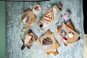 Assorted sweet desserts. Top view. Gray textured background. Beautiful serving dishes. Dessert. Food chain