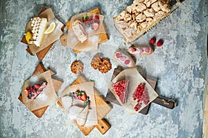 Assorted sweet desserts. Top view. Gray textured background. Beautiful serving dishes. Dessert. Food chain