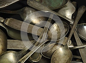 Assorted tarnished antique spoons and knives