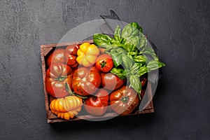 Assorted tomatoes in rustic crate