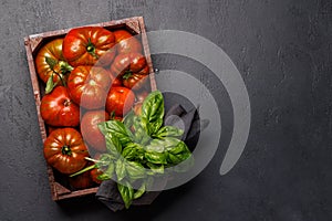 Assorted tomatoes in rustic crate