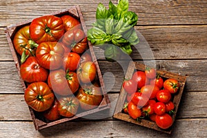 Assorted tomatoes in rustic crate