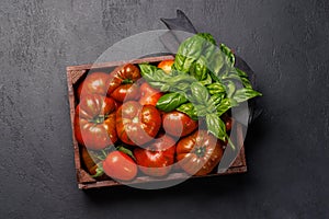 Assorted tomatoes in rustic crate