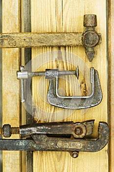 Assorted tools aranged on a wooden bench in yellow color