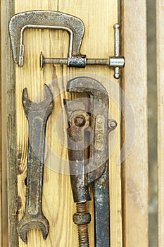 Assorted tools aranged on a wooden bench in yellow color