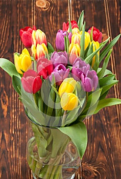 Assorted Tulips Bouquet. Burned Wooden Background. Copy Space