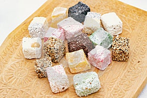 Assorted Turkish delight on a carved wooden board