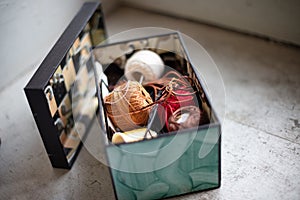 Assorted twines, string and thread rolls in an open box