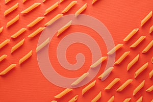 Assorted types of pasta organized on orange background. flat lay concept top view. Place the text