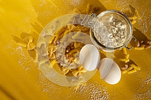 Assorted types of pasta on yellow background. Various forms of pasta. Close up