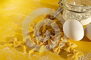 Assorted types of pasta on yellow background. Various forms of pasta. Close up