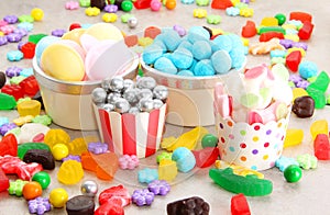 Assorted variety of sweet sugar candies includes bonbons, gummy bears, gum balls and sugar fruit slices
