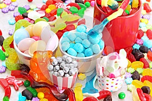 Assorted variety of sweet sugar candies includes, gummy bears, gum balls and sugar fruit slices