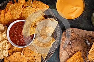 Assorted from various types of potato chips and pita chips, snacks for parties and parties, with salsa and dip. Fast and tasty