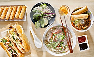Assorted vietnamese dishes with pho, bahn mi, spring rolls photo