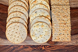 Assorted Whole Grain and Herb Crackers on a Wooden Cutting Board