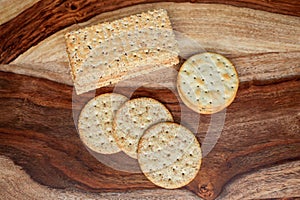 Assorted Whole Grain and Herb Crackers on a Wooden Cutting Board