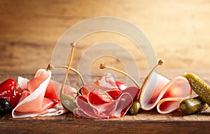Assorti of sliced jamon, salami, ham with olives ,capers, pickles and stuffed red peppers