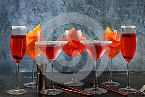 Assortment of alcoholic cocktail Aperol spritz, champagne and red martini in glasses on a dark background, bar concept, alcoholic