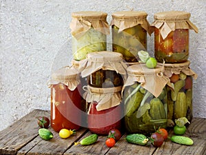 Assortment autumn preserves. Jars of pickled vegetables and jam.