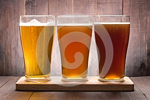 Assortment of beer glasses on a wooden table