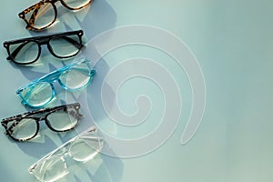 An Assortment of Blue Light Blocking Reading Glasses on Light Blue Solid Background