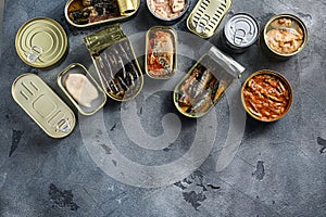 Assortment of cans of canned with different types of fish and seafood, opened and closed cans with Saury, mackerel, sprats,