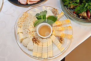 Assortment of cheese sliced on a platter.