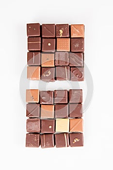 Assortment chocolate pralines in top flat view in white background