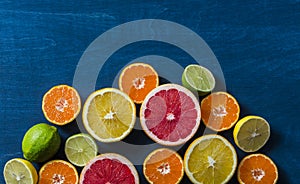 Assortment of citrus fruits on a blue background, top view. Oranges, grapefruit, tangerine, lime, lemon - organic fruits, vegetari