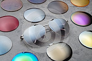 Assortment of colored lenses for sunglasses on table in optical store