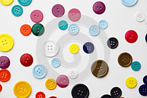 Assortment of colorful buttons on white background