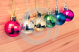 Assortment of colorful christmas tree baubles in a row