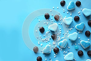An assortment of colourful, festive sweets, lue marmalade in the shape of a heart on a blue background with a variety of