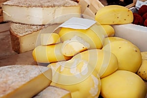 Assortment of craft cheese on the counter of the farmers ' market. The farmer's market presents the products of a small