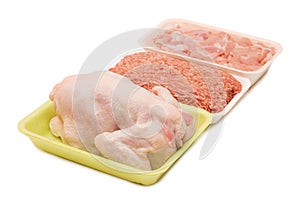 Assortment of crude meat in trays isolated