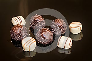 Assortment of dark, white and milk chocolate with nuts. Chocolate candies and pralines.