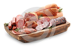 Assortment of delicious deli meats on wooden board, isolated on white