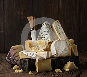 Assortment of different cheese types on wooden background. Cheese background