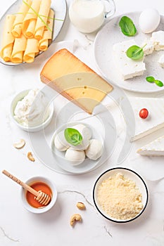 Assortment of different dairy products on white table