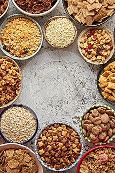 Assortment of different kinds cereals placed in ceramic bowls on table