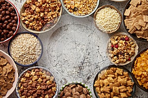 Assortment of different kinds cereals placed in ceramic bowls on table