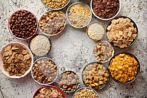 Assortment of different kinds cereals placed in ceramic bowls on table