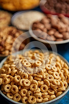 Assortment of different kinds cereals placed in ceramic bowls on table