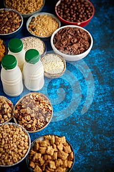 Assortment of different kinds cereals placed in ceramic bowls on table