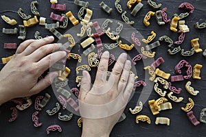 Assortment of different kinds of pasta on black background