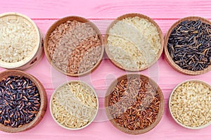 Assortment of different rice in bowls: white rice red rice black rice a mixture of wild and brown rice. The whole grain of rice.