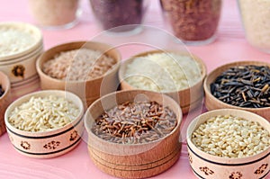 Assortment of different rice in bowls: white rice red rice black rice a mixture of wild and brown rice