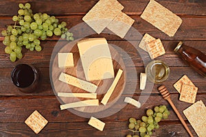 Assortment of different varieties of cheese, red wine, grapes and cracker, the basis of the French diet, healthy and natural food