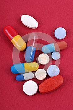 Assortment of drugs close-up on red background